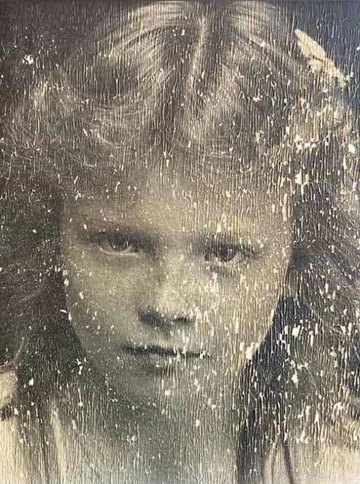 Scratched faded child portrait before AI old photo restoration